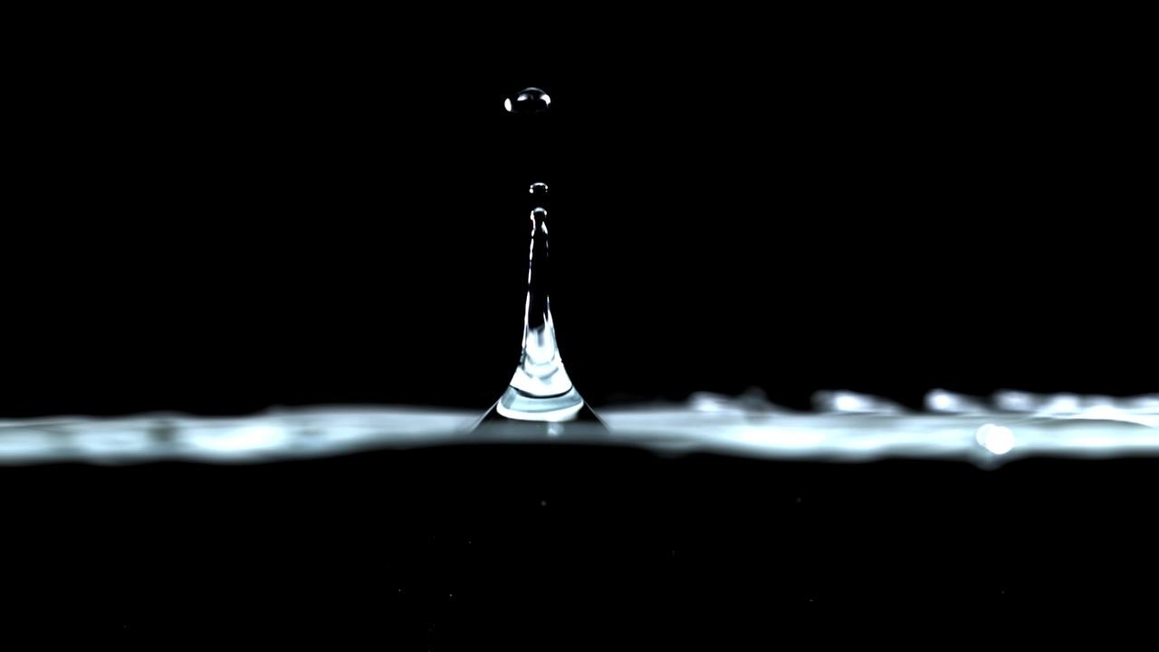 Slow Motion Water Drop Falling and Splashing on a Black Background