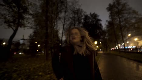 woman walking in park at night