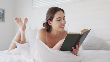 Mujer-Caucásica-Feliz-Relajándose,-Acostada-En-La-Cama-Y-Leyendo-Un-Libro