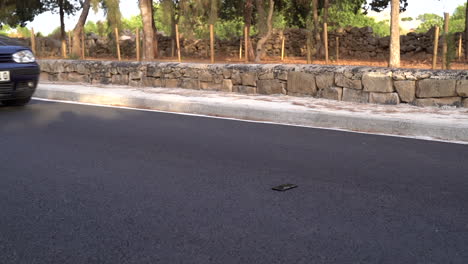 Car-tires-driving-over-mobile-smart-phone-gorilla-glass-on-normal-road-with-tarmac---wide-angle