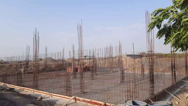 Construction works fabricating steel reinforcement bars at the construction site