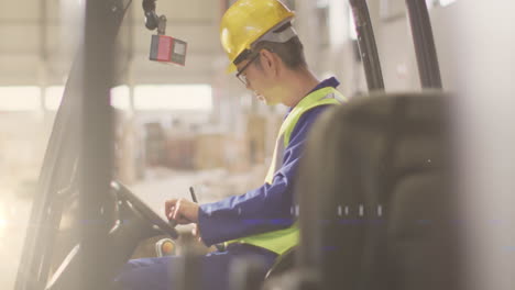 animation of glowing light over asian man working in warehouse