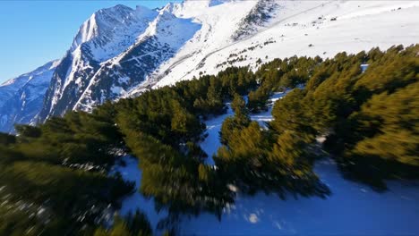 scenic fpv aerial view flying quickly over the snowy mountain wilderness of the pyrenees