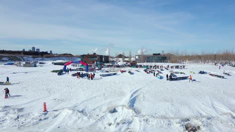 drone pan right, people preparing for canoe race