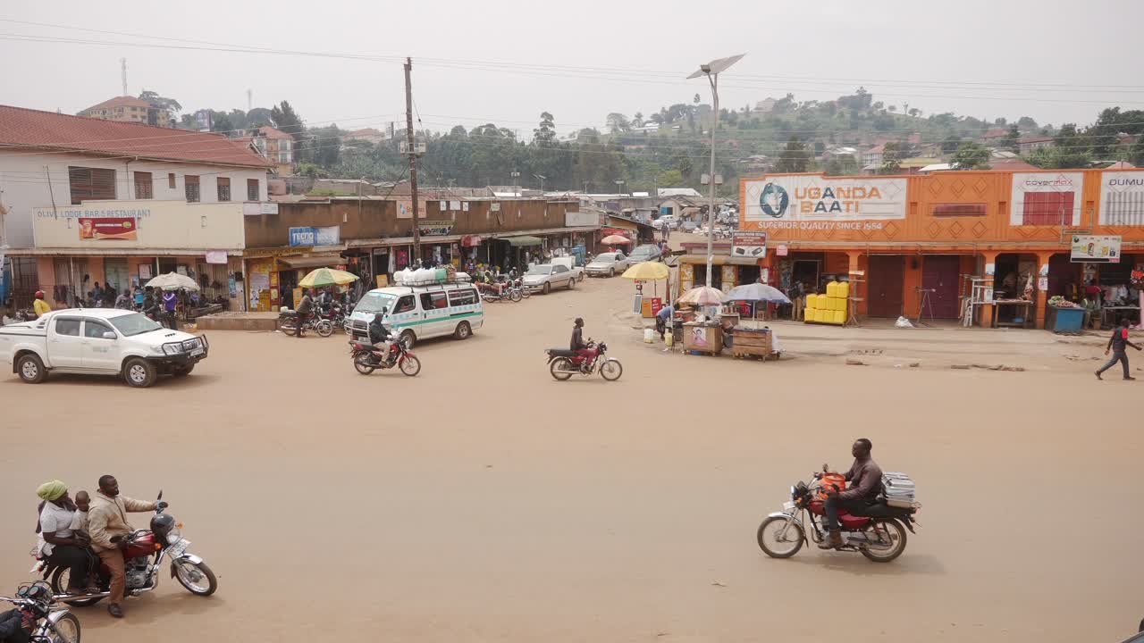 Long shot of motorbikes and cars in a big city of Uganda.