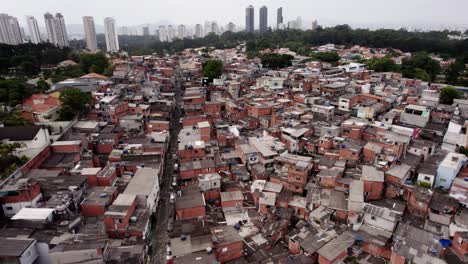 aerial view over suburban dwellings in a poverty area, in cloudy sao paulo, brazil