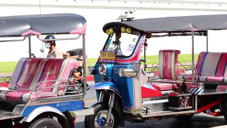 tuk-tuk parked on a bangkok street