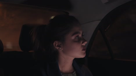 Hermosa-Chica-Viajando-En-Un-Taxi-Por-La-Noche-Sentada-En-El-Asiento-Trasero-Y-Enviando-Mensajes-De-Texto-Usando-Su-Teléfono-Inteligente.-Mujer-Joven-En-Taxi.-Noche