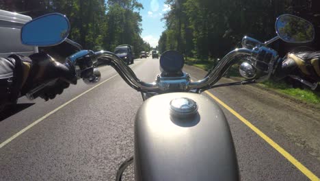 riding a motorcycle. biker rides on the road with a first-person.