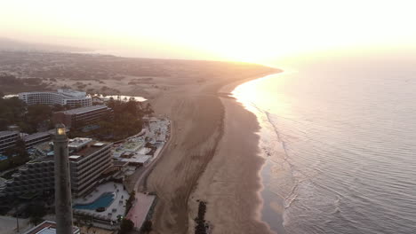 aerial sunset shot of lighthouse of maspalomas in gran canaria, canary islands, spain