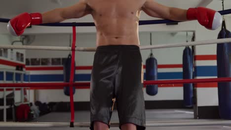 caucasian man resting in boxing ring