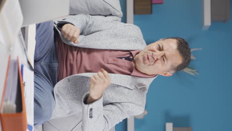 Vertical-video-of-Home-office-worker-old-man-dances-looking-at-camera.