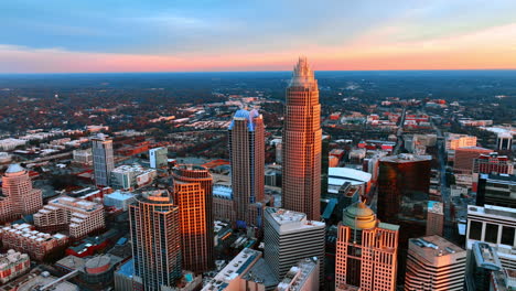 pink light coloring the facades of skyscrapers in the uptown of charlotte, north carolina, usa. top view. amazing colored sky at backdrop