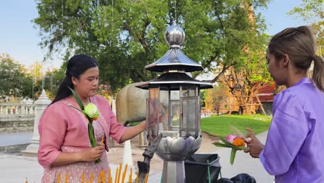 people praying at a buddhist temple in thailand