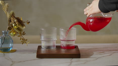 pouring a refreshing red drink