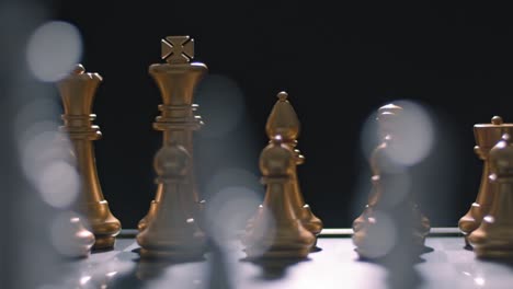 Opponent's-view-of-gold-chess-pieces-on-chess-board