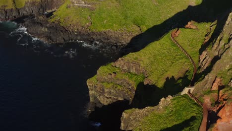 aerial dolly shot of the giant's causeway walkway and rugged coastline from above