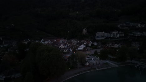 aerial view of a residential neighborhood showcasing the lake walensee in switzerland during late evening, as dusk softly envelops the landscape, creating a tranquil and picturesque setting.