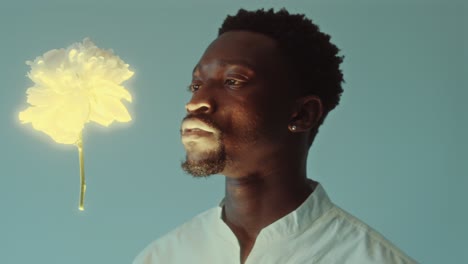 young african american man watching magic flower levitating in the air