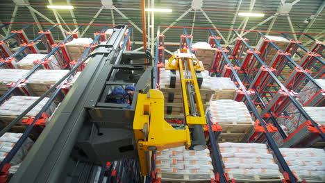 forklift loading pallets in high bay warehouse