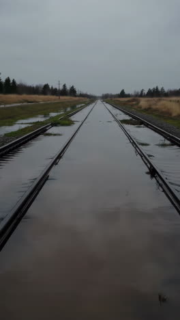 flooded railroad tracks on a gloomy day