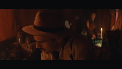a man in hat checks the inside of the gypsy circus cart