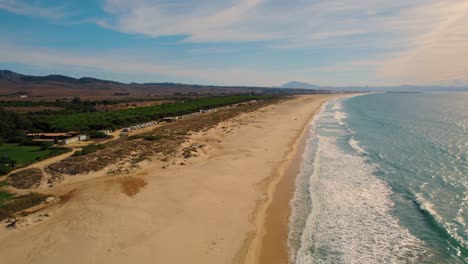 aerial landscape view of the beach and endless horizon during sunset at tarifa, spain