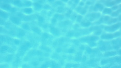 Light-glimmering-on-blue-swimming-pool