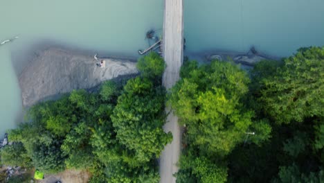 top view dolly of a bridge over a river with a truck driving across the bridge