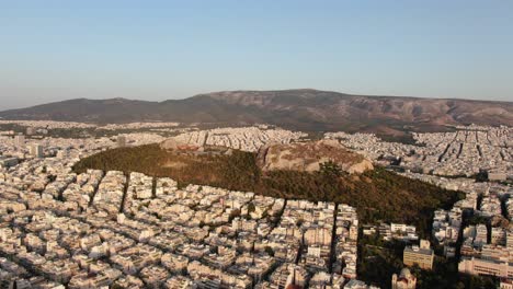 Aerial-view-of-Lycabettus-Hill,-circular-tracking-while-zooming