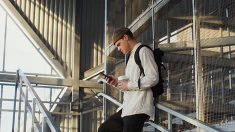 young man on stairs using phone