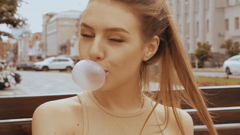 young woman blowing bubbles in the city