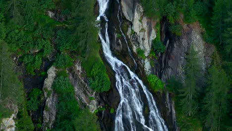 slow motion of mountain waterfall in valmalenco valley of valtellina in summer season, northern italy