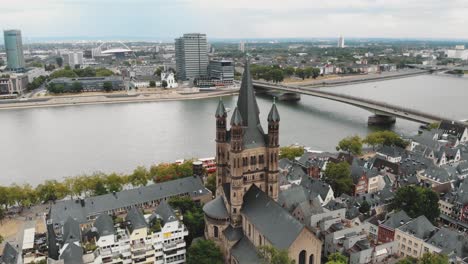 aerial drone footage of cologne cathedral along the shore of the rhine river in germany