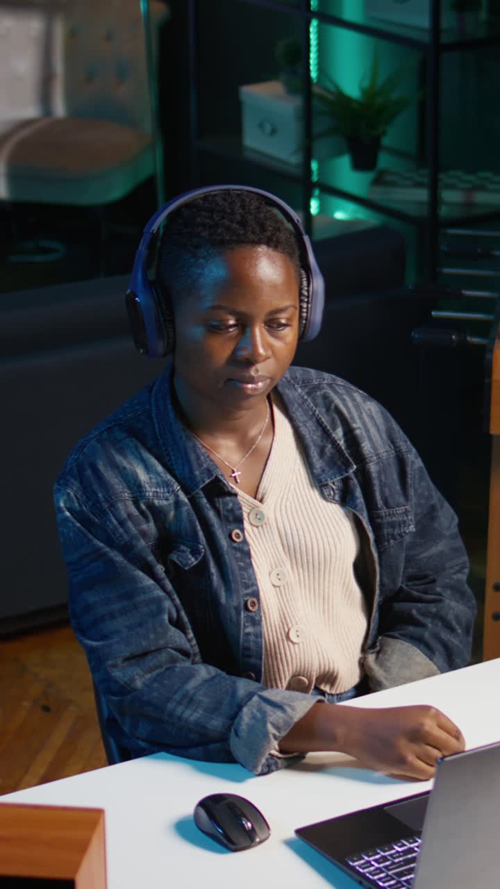 Vertical video Freelancer doing computer tasks while listening music