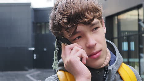 teenager talking on phone outdoors