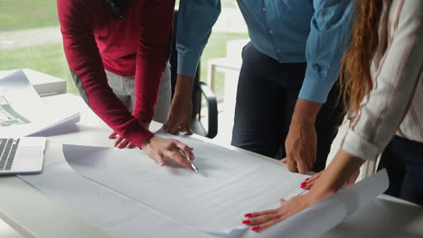 cropped shot of young architects working with blueprints.