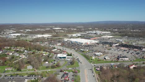 4K-Aerial-Drone-footage-of-industrial-shopping-centers-and-strip-malls-in-Middletown-New-York-and-traffics-can-be-seen-with-mountains-in-the-background