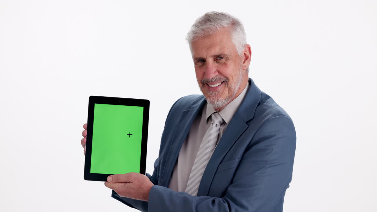 Senior man holding tablet with green screen