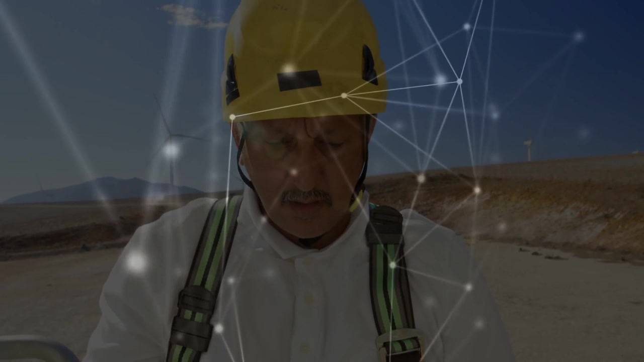 Male tech performing checks arriving wind farm, overlay highlighting straps and turbines for safety
