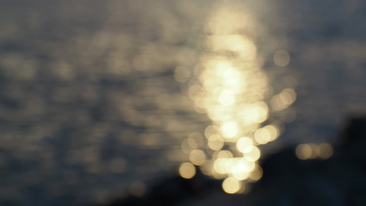 bokeh circles dancing on the water at sundown