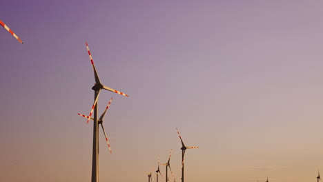 wind turbines stand tall at sunset. tall wind turbines tower against a colorful sunset sky, symbolizing renewable energy and sustainable power solutions