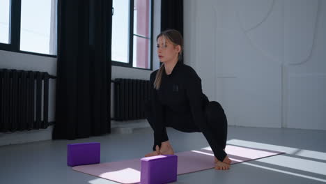 woman practicing yoga in a studio