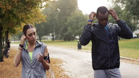 athletic couple running in park wearing wearable technology connected devices