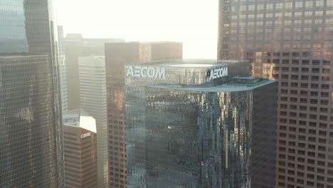 AERIAL:-Close-up-AECOM-Skyscraper-in-Downtown-Los-Angeles,-California-Skyline-at-beautiful-blue-sky-and-sunny-sunny-flair-Day