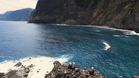 rock isle reef with cave near steep ocean coast cliffs of madeira