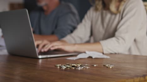 Close-up-of-caucasian-woman-with-senior-man-checking-home-budget.