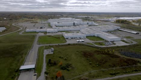 general motors auto plant in delta township, michigan with drone video moving in a circle wide shot