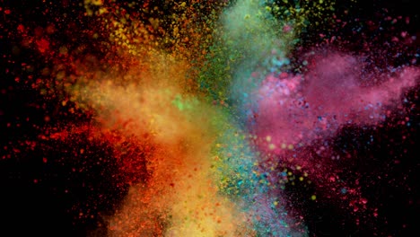 super slow motion of colored powder explosion isolated on dark background.