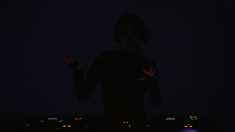 woman dj mixing music in a club